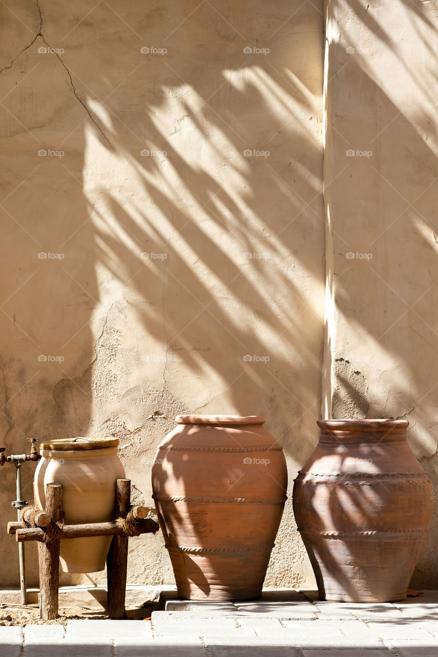 Beautiful diagonal shadows. Ceramic clay pots as part of UAE heritage.