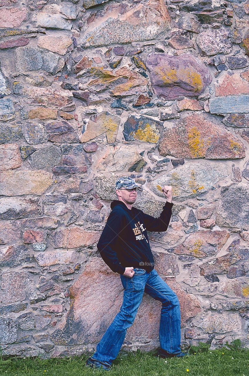 Man against a stone wall