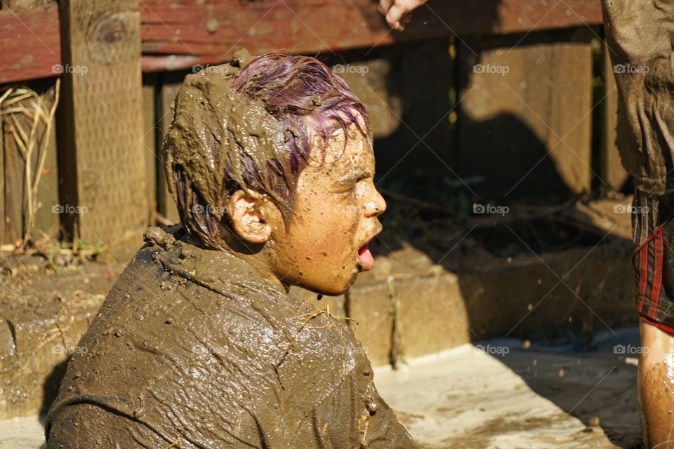 Boy Playing In The Mud