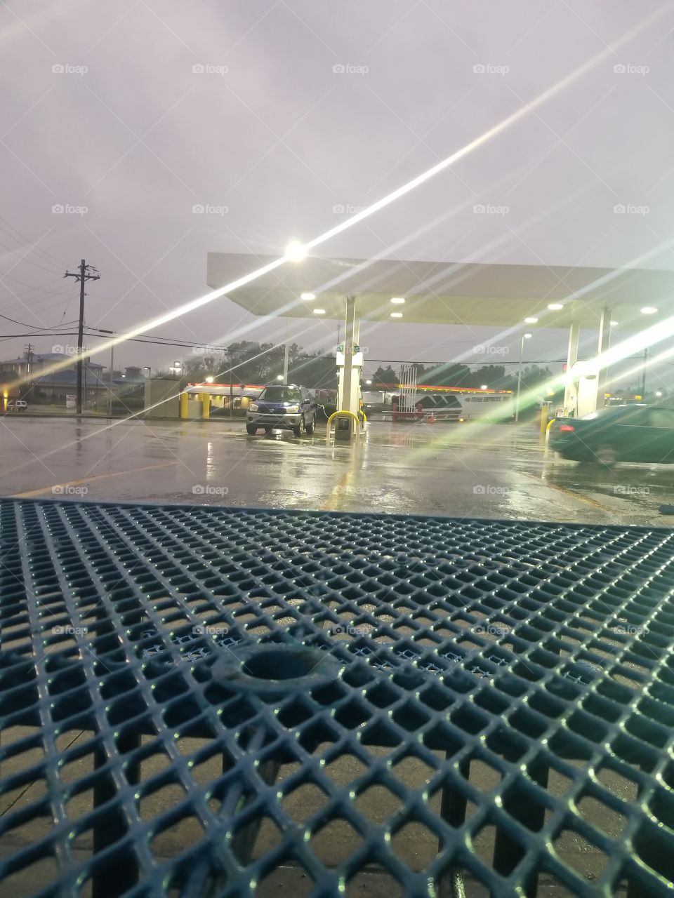 rainy gas station parking lot