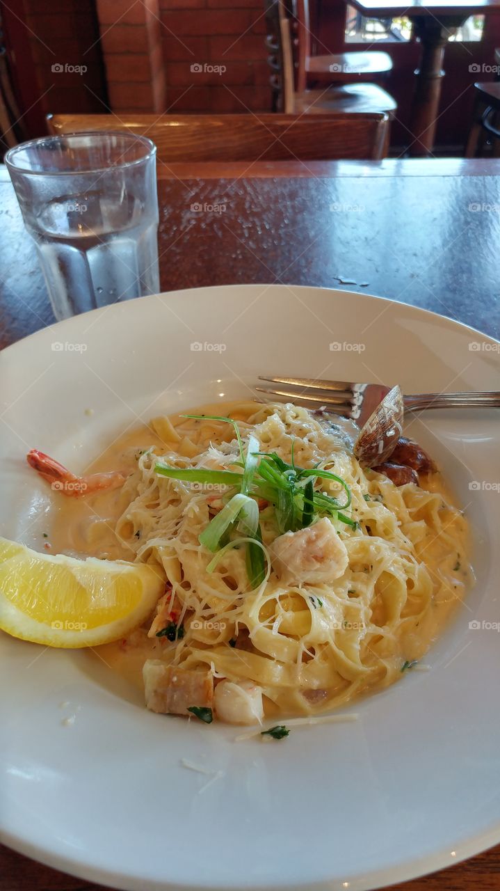 seafood alfredo on a white plate