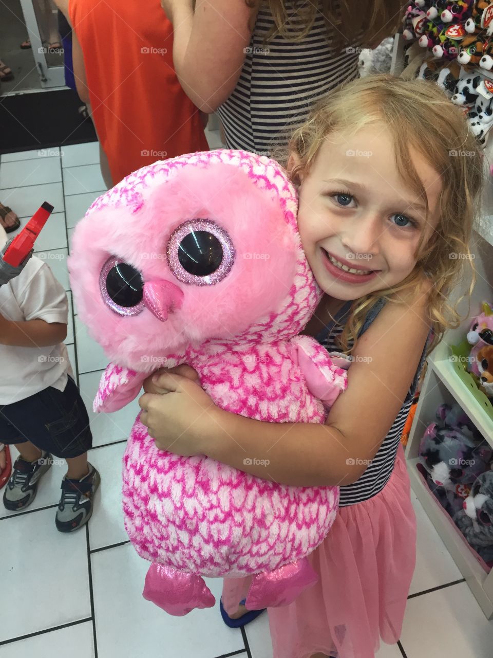 Happy girl carrying teddy bear