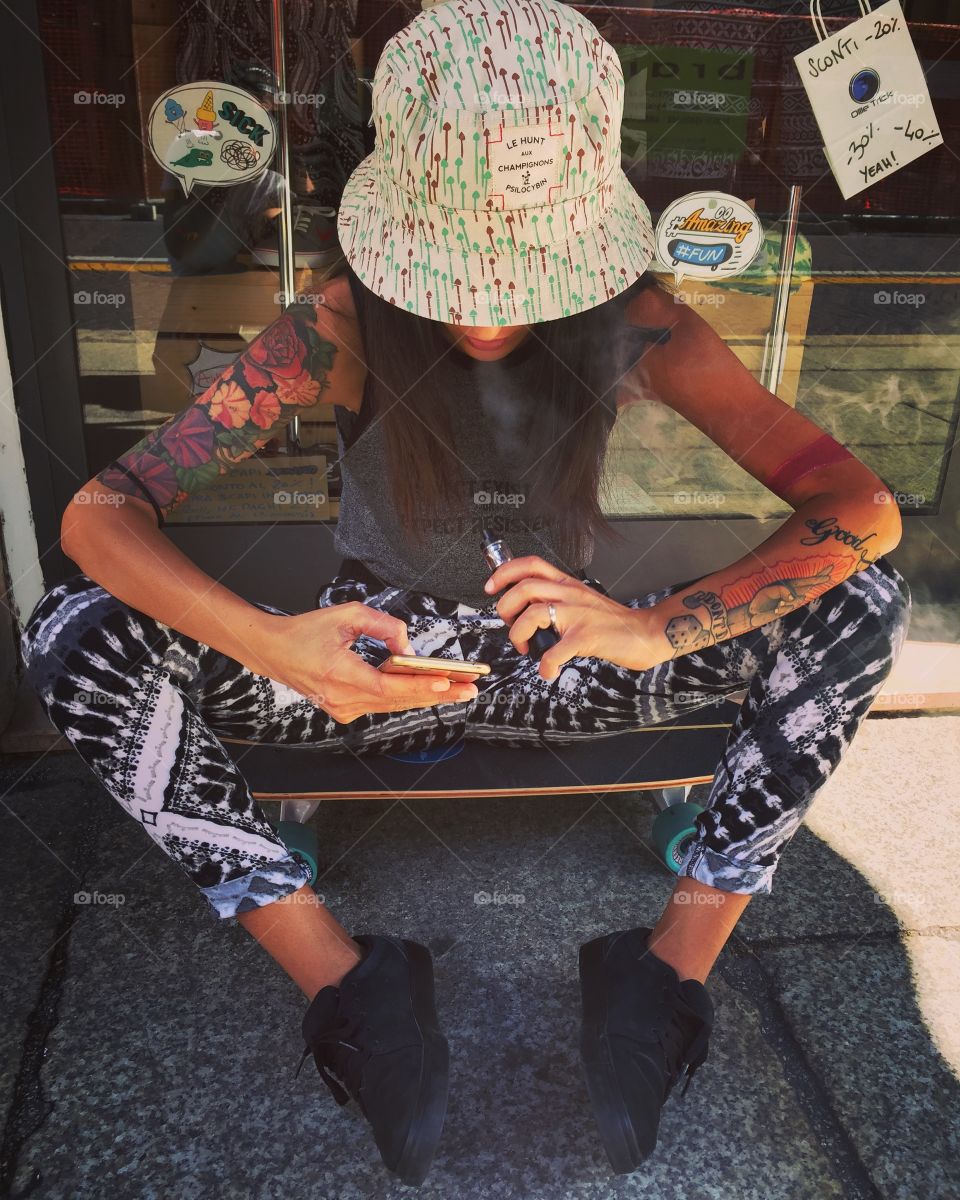 woman skater sitting in front of a store