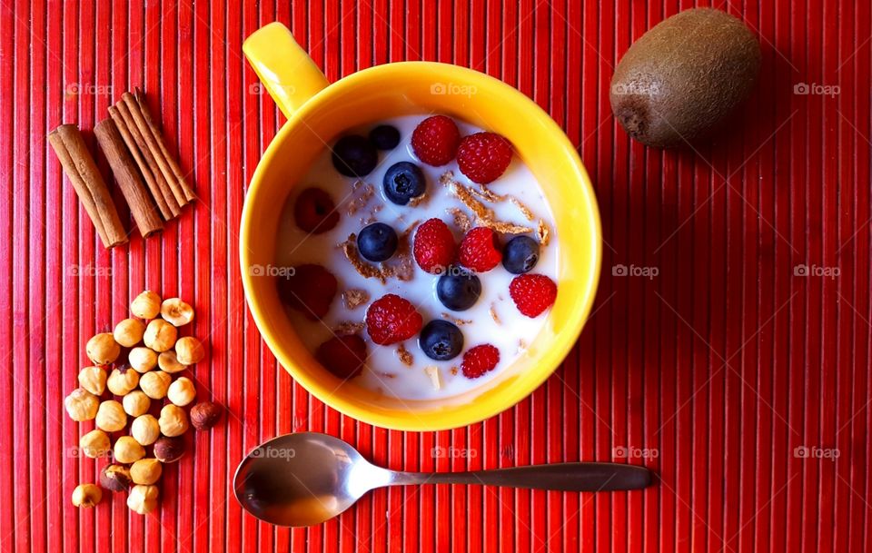 Bowl of berries and nuts with milk