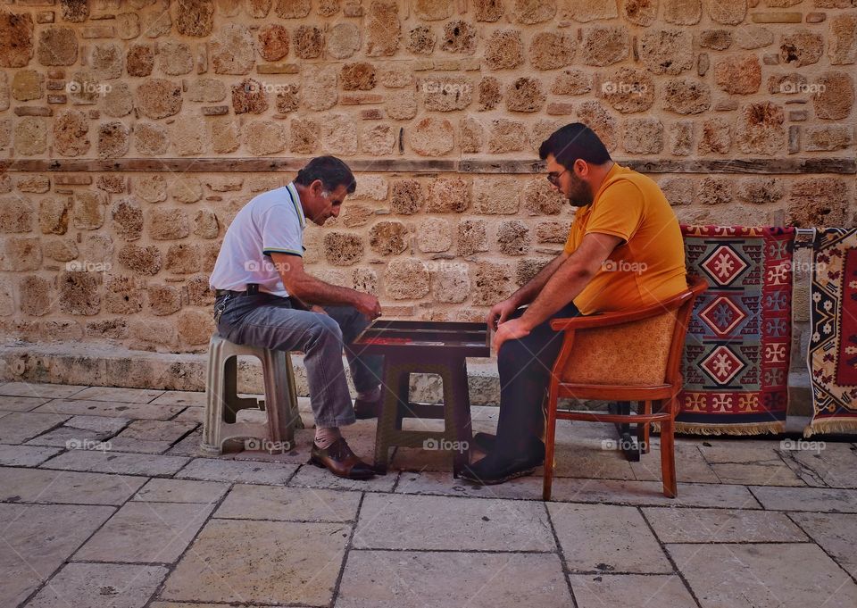 Gamers.
Took this picture in Antalia, Turkey. Went for a walk in old part or the city and noticed those two. Decided that it could not a bad street are shot. Those men are playing a backgammon.