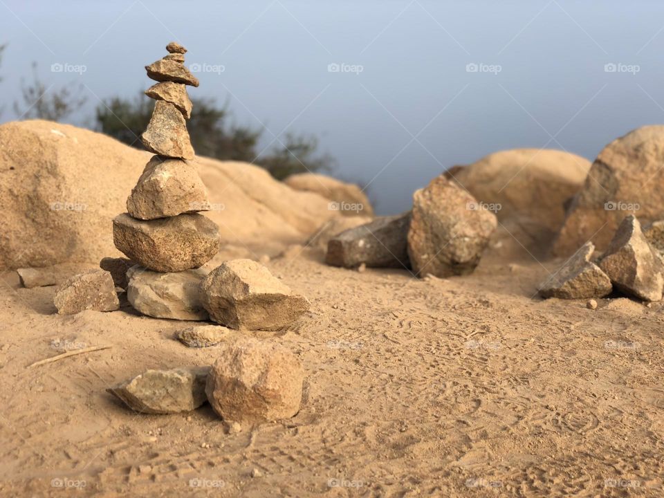 rock balancing/cairns/stacks at the top of a mountain on an early morning hike