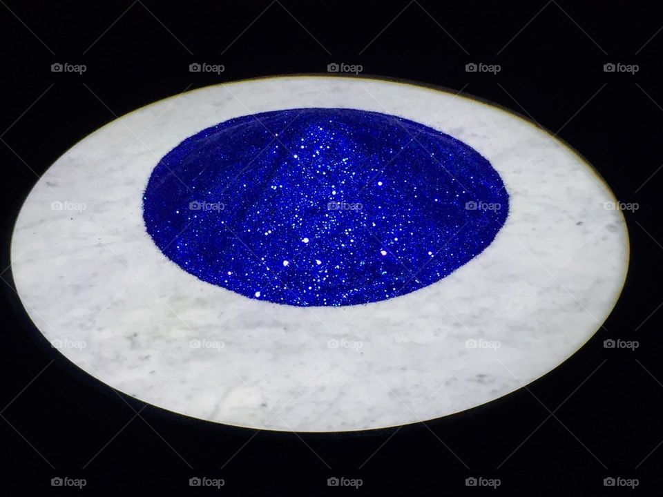 Modern art object round item with shine blue middle