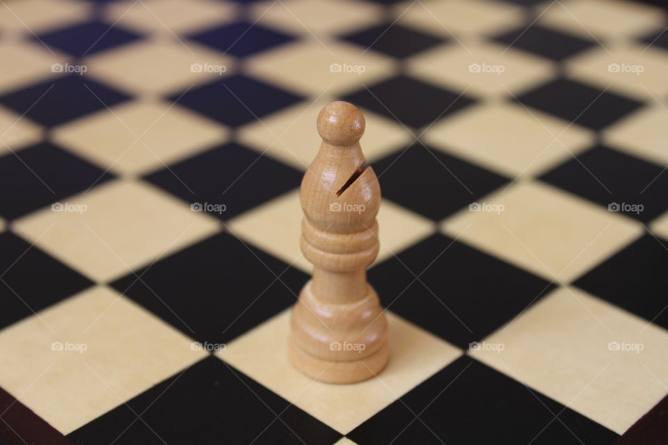 miniature chess piece on chess board