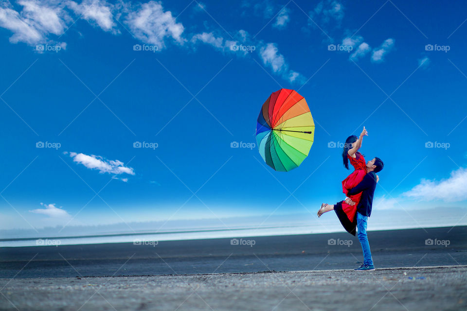 Man carrying woman on beach