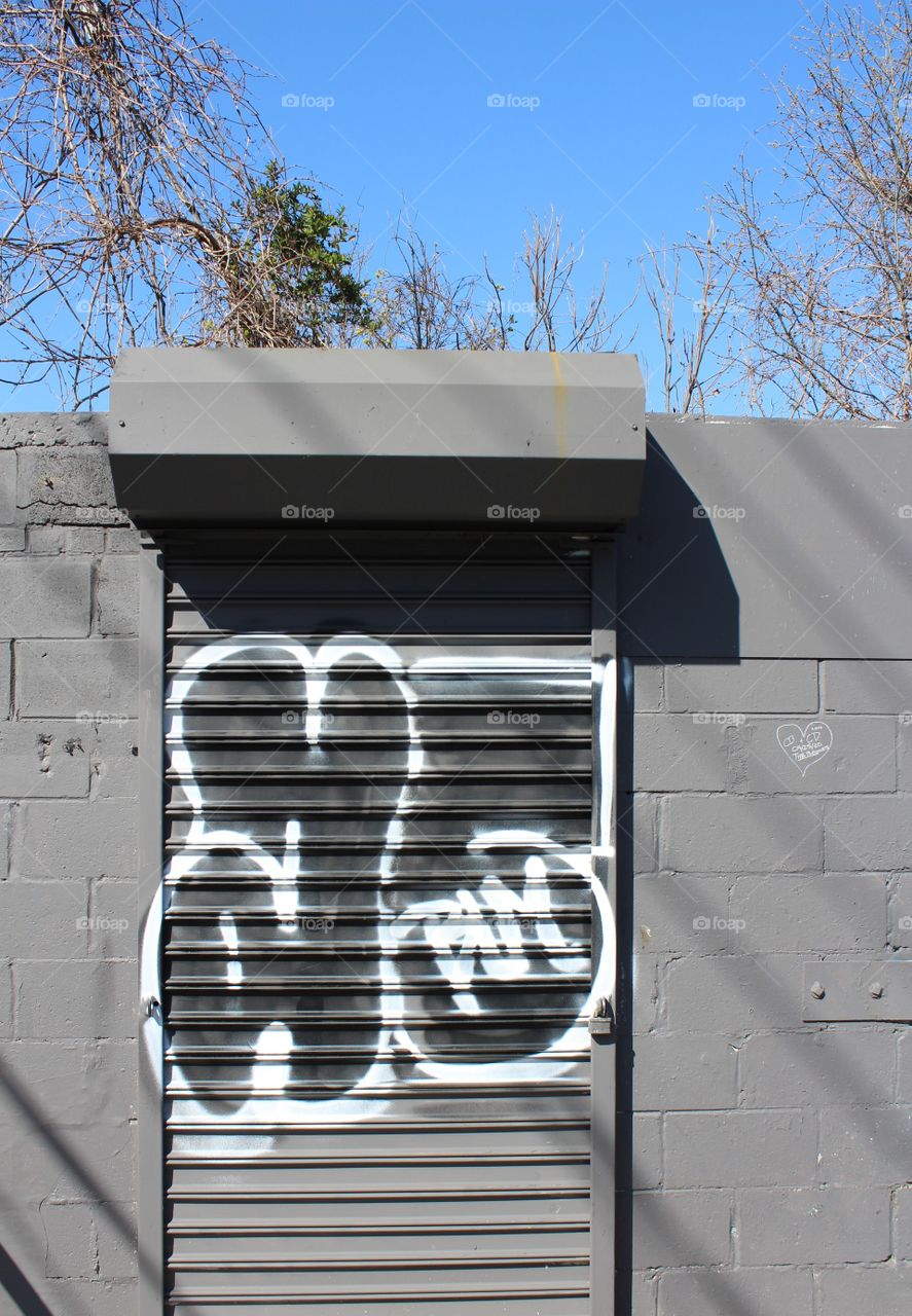 Graffiti tag on gray wall 