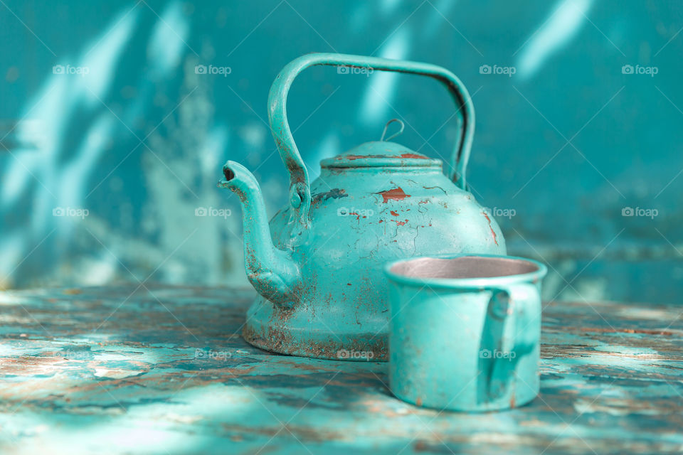 Turquoise rustic teapot and tin can