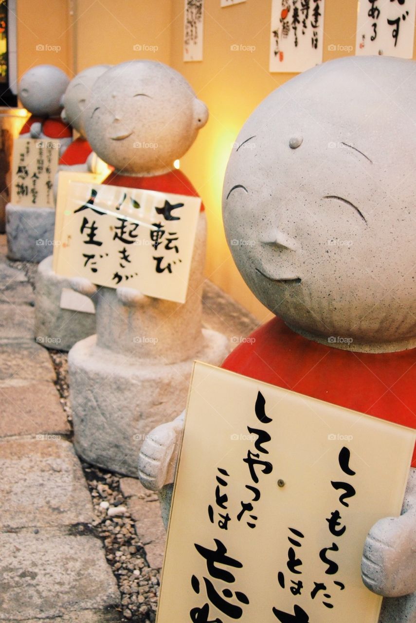 Happy faces holding signs