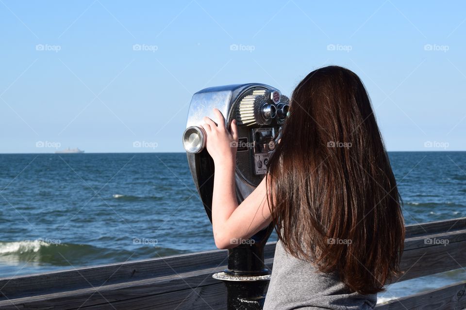 Tourist at coin operated binocular