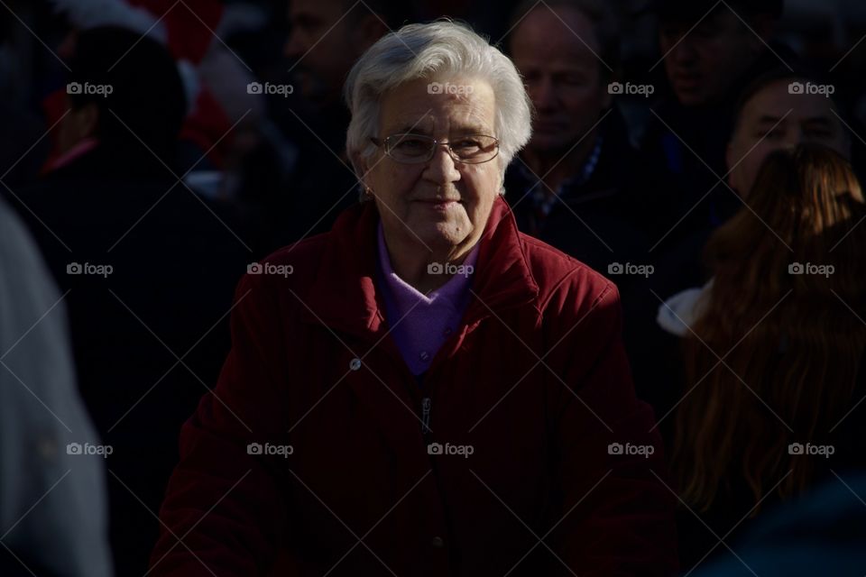 Street Photography.Elderly woman in a crowd.