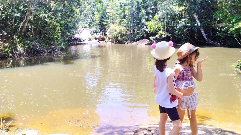 children playing on the riverbank in contact with Nature