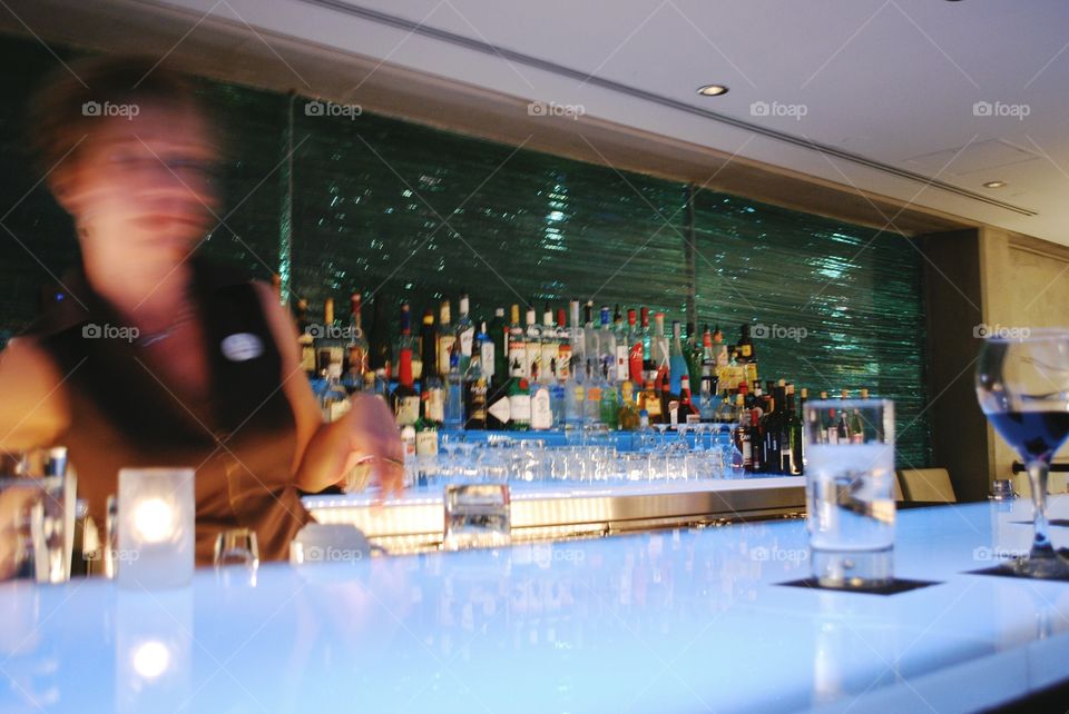 A bartender is shown quickly moving around the bar.