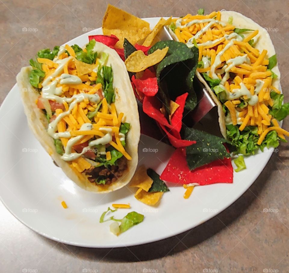 A delicious colorful taco with a creamy avacodo sauce and crunchy tortilla chips