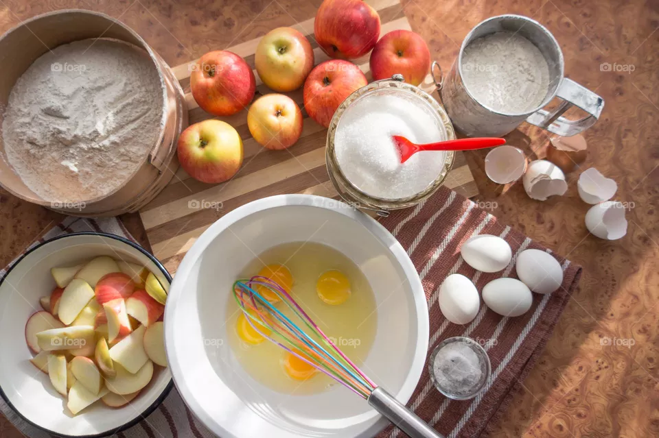 Making homemade puffed apple pie with eggs, sugar and flour.