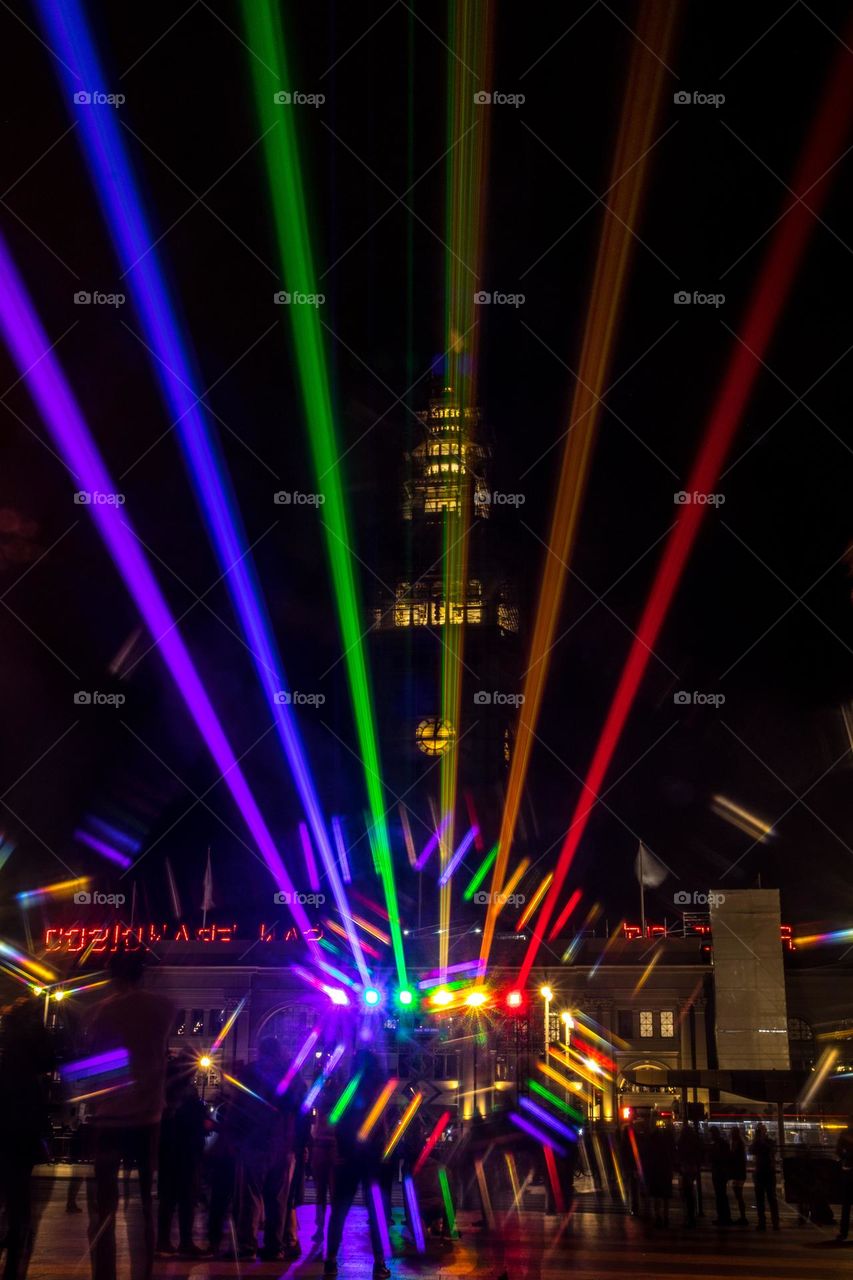 San Francisco Pride 2023 laser light display of the pride flag colors illuminating the sky in front of the Ferry Building on the Embarcadero 