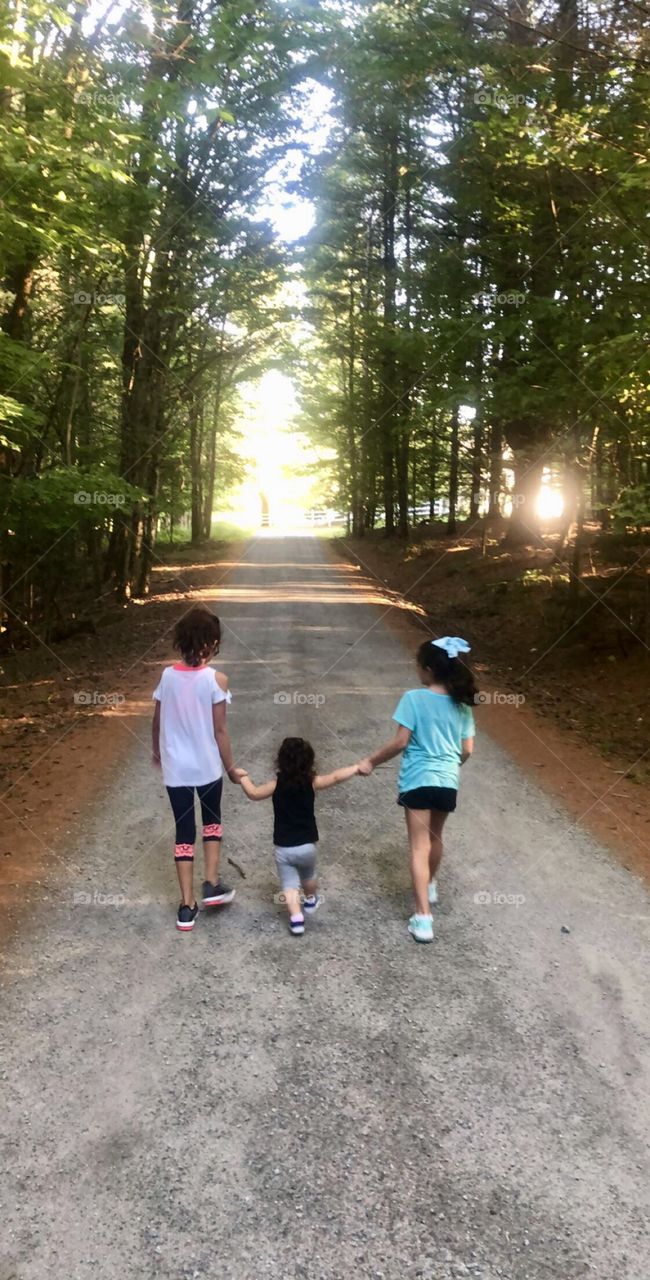 Three sisters walking on a path