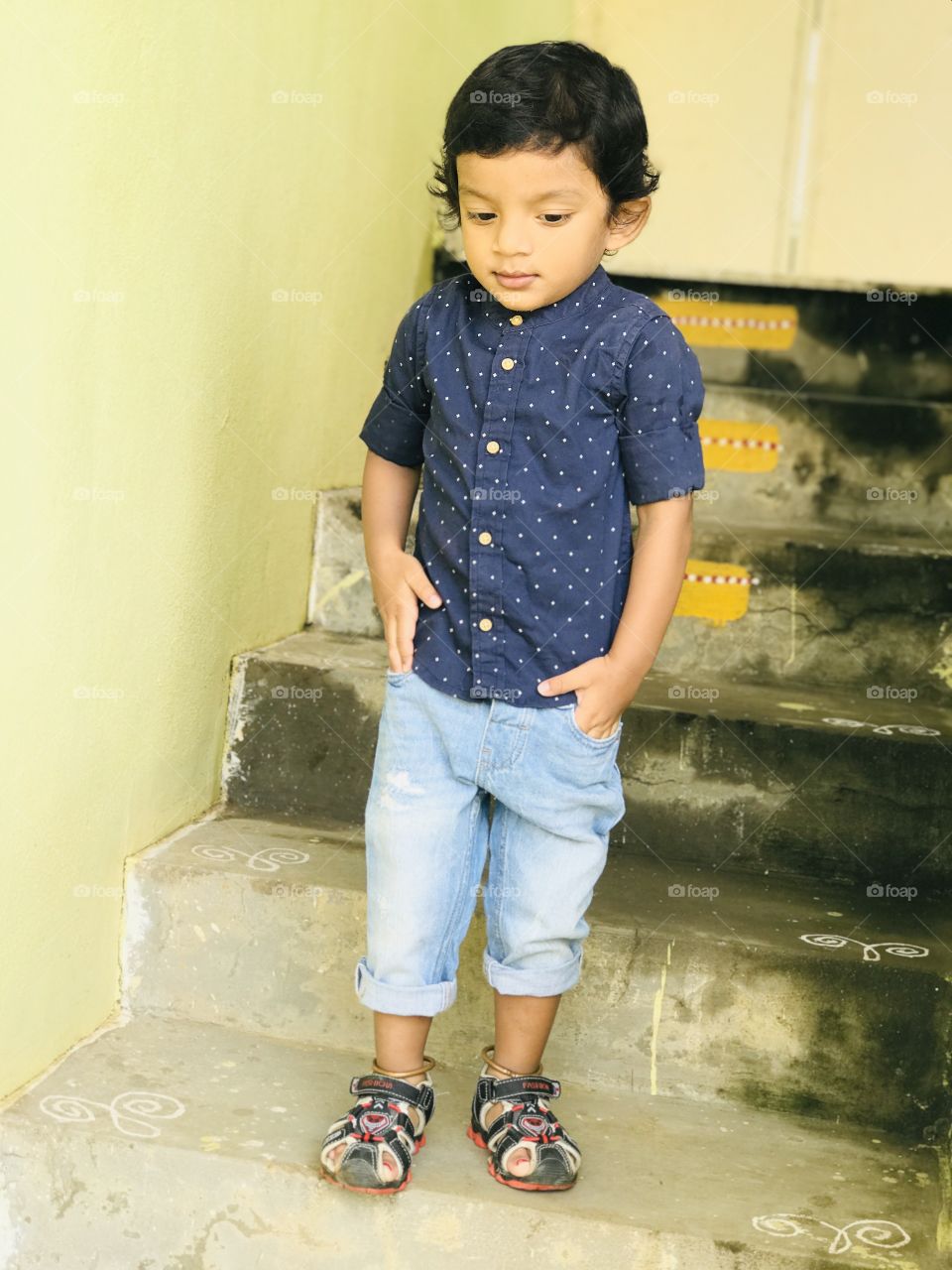 Indian trendy baby boy with blue dot design dress and wearing jeans 