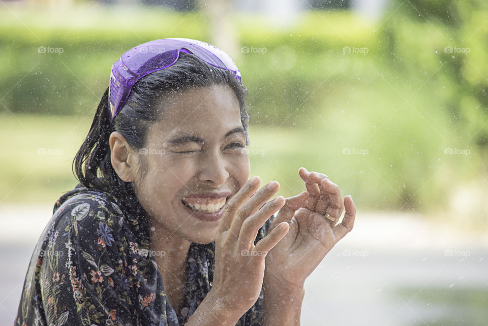 Asian woman play water in Songkran festival or Thai new year in Thailand.