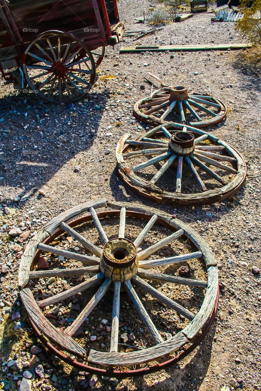 Old broken wagon wheels scattered on the ground, a sign of days gone by f the old wild Wild West 