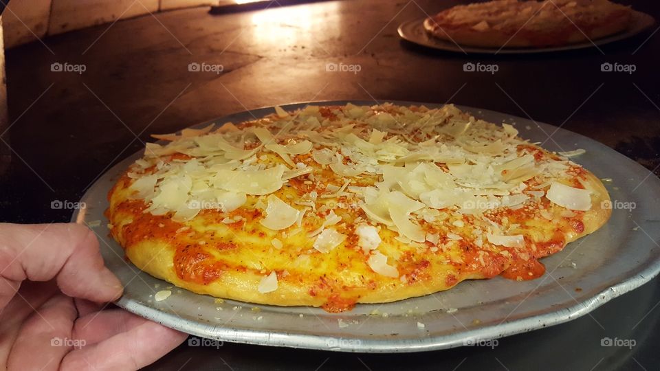 pizza going in oven