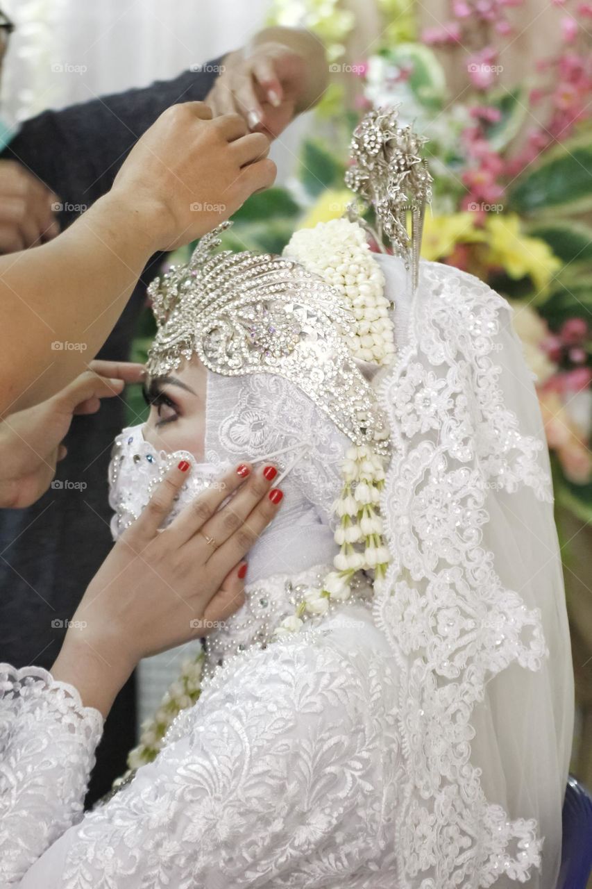 Making up the Bride for wedding ceremony. Siger is a crown by sundanese brida