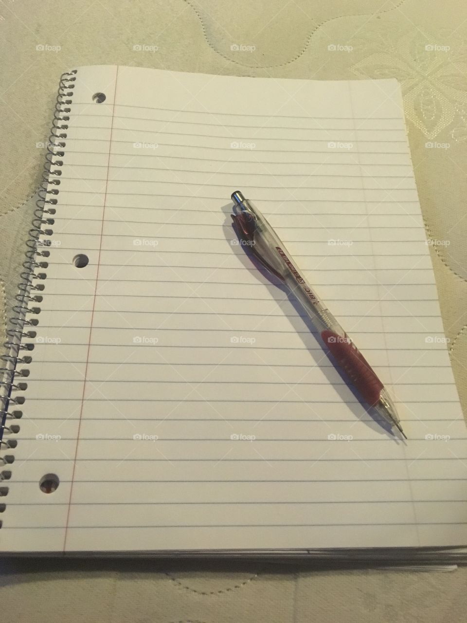 A blank piece of notebook paper and a mechanical pencil 