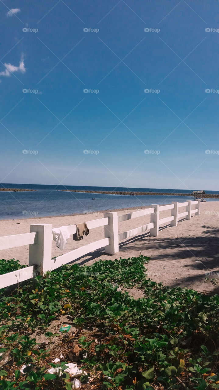 The fence that separates the ocean from the huts where guests of the resort stay.