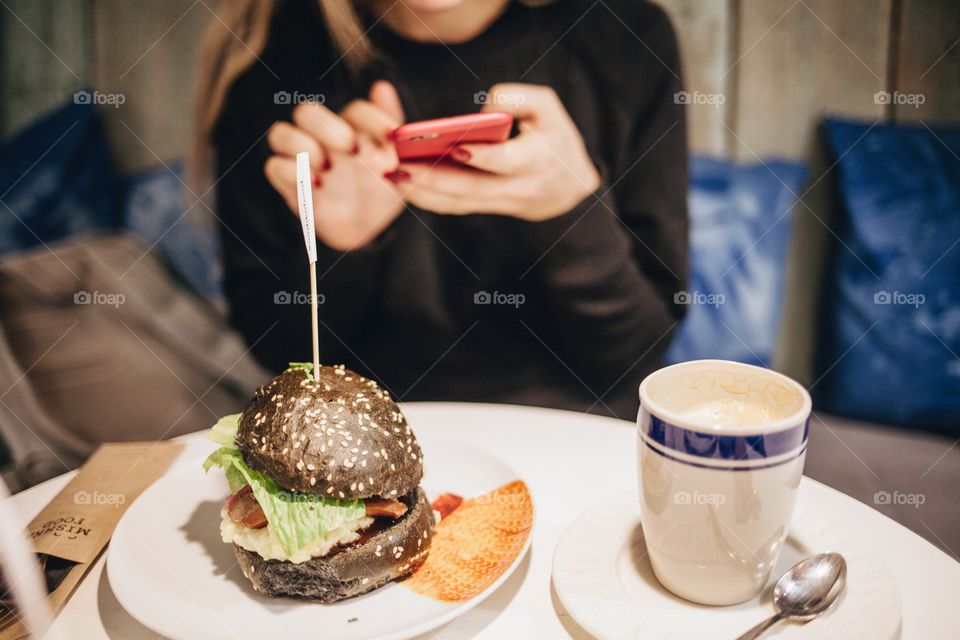 Girl at breakfast using mobile