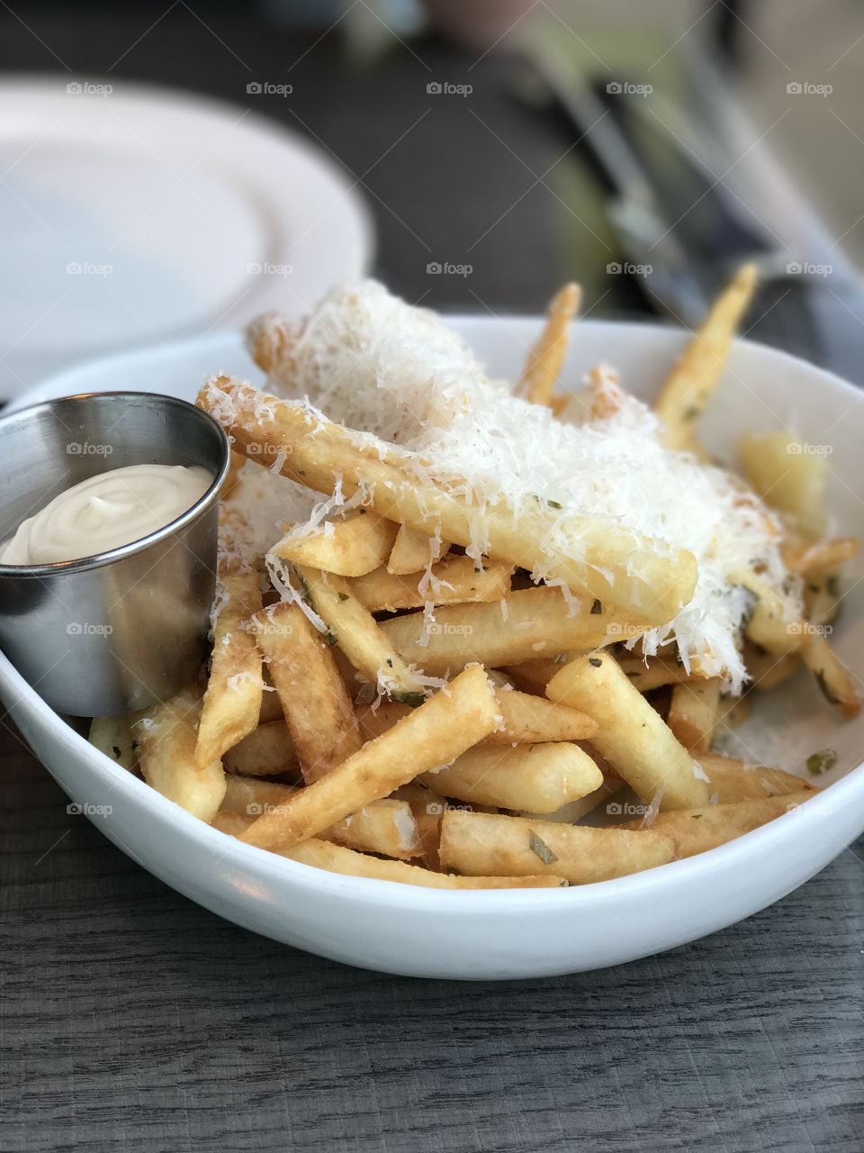Crispy Truffle French fries with fresh grated parmesan and a herb mayo for dipping. 