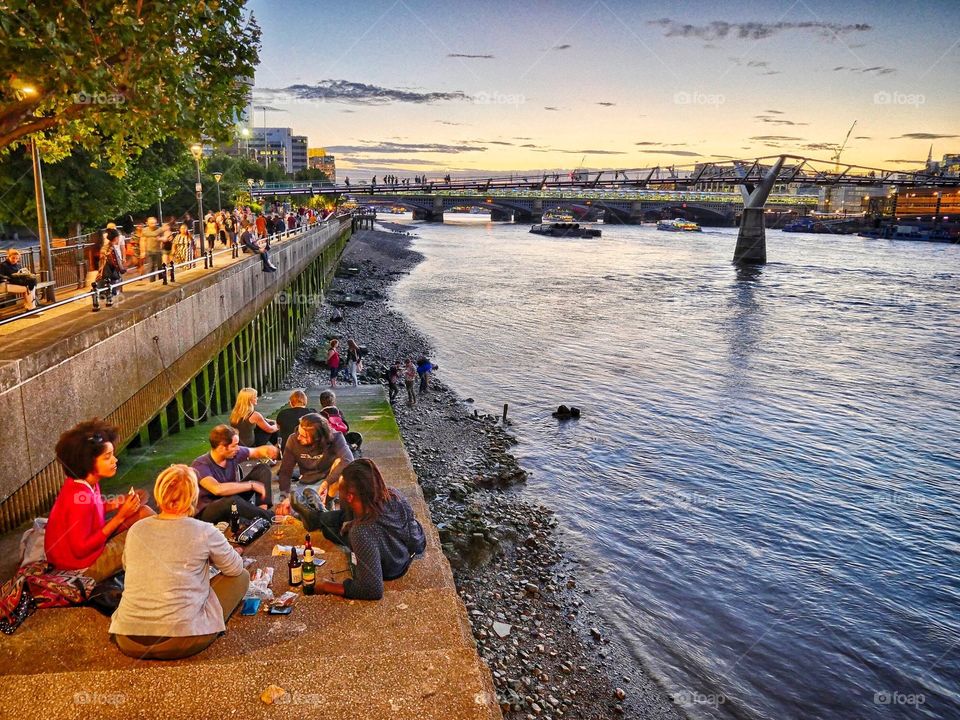 Youth having a picnic by the river Thames