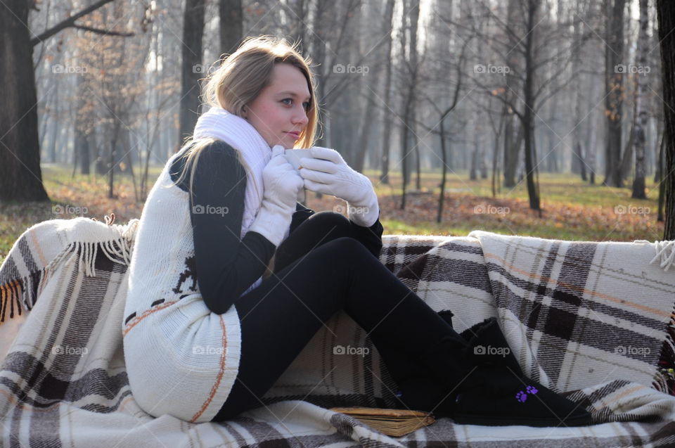 Autumn park and warm blanket . Sitting on the bench autumn time 