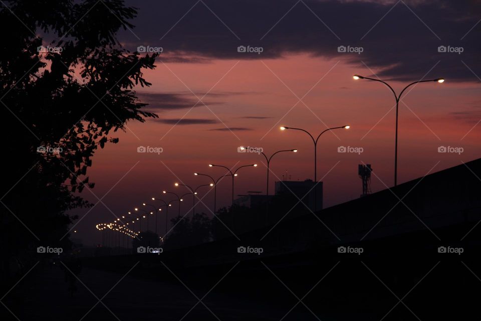 Twilight over the highway and the streetlights are lit up