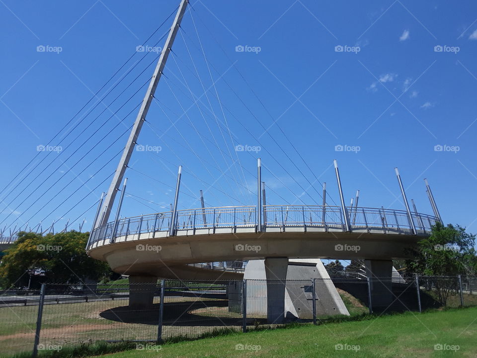 A park nearby and the architectural bridge, the blue sky view.
