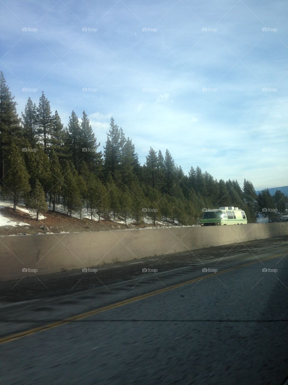 Driving through the snowy mountains with a blue sky over our heads. 