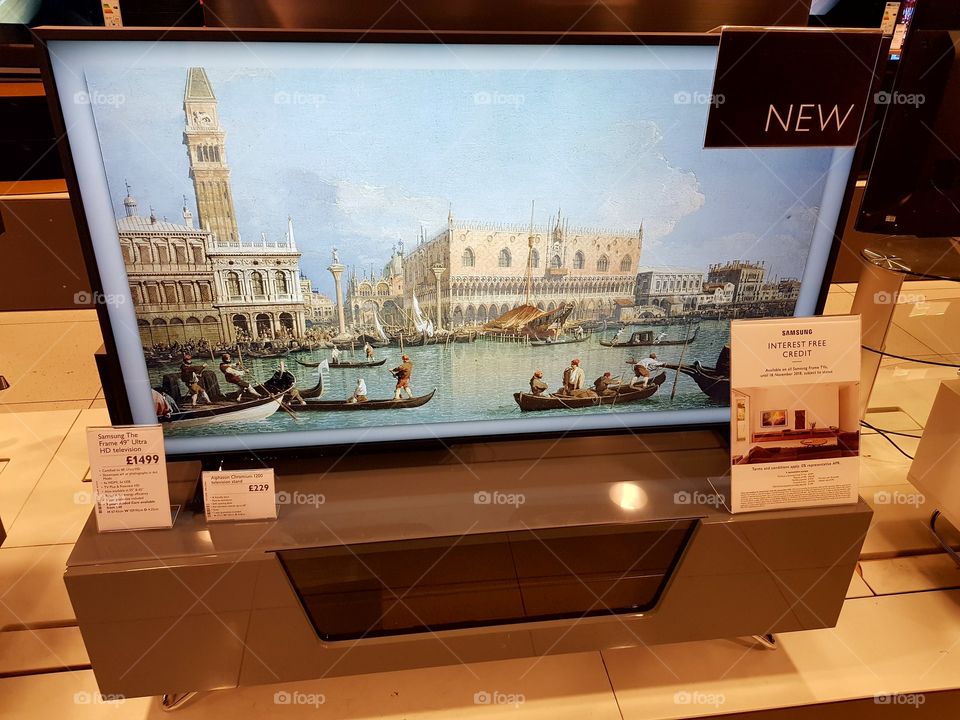 Samsung 49" The Frame art mode TV on grey and glass television stand