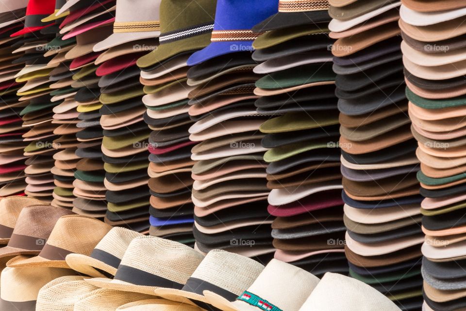 Felt hats on sale. Piles of felt hats on display. Many colors. Photo filled with hats
