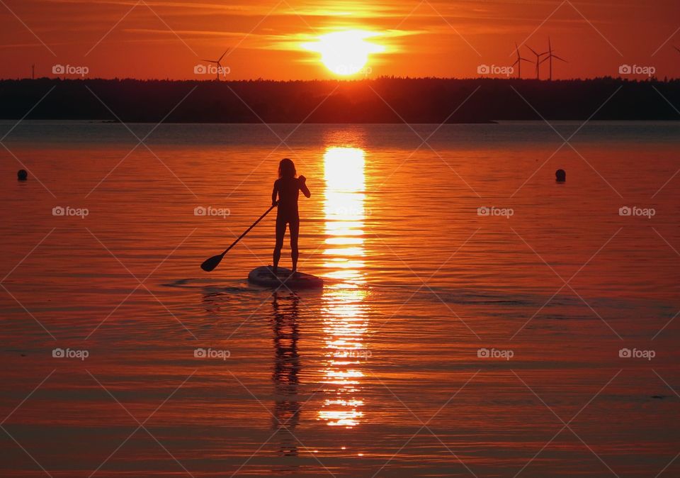 Standup paddling in sunset