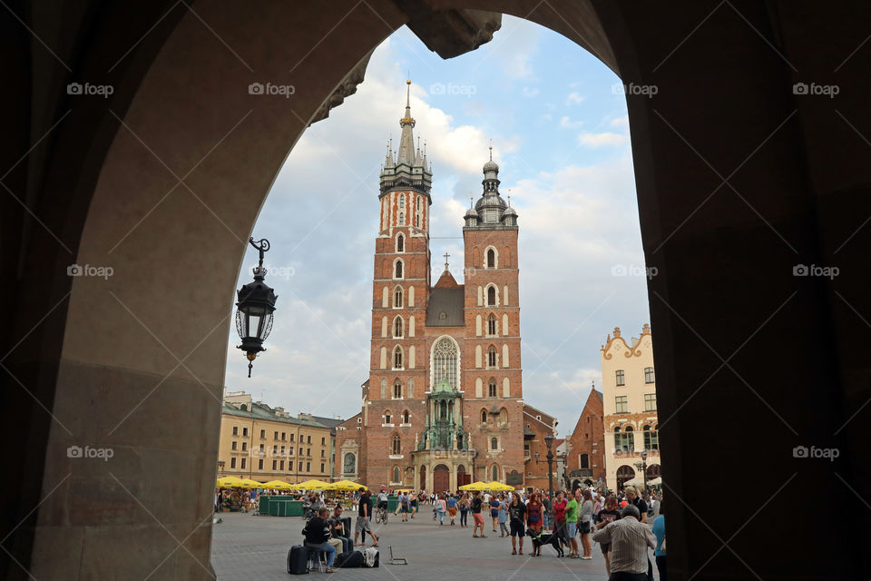 St. Mary’s Basilica (Bazylika Mariacka) in Krakow, Poland, seen through the arches of the market.