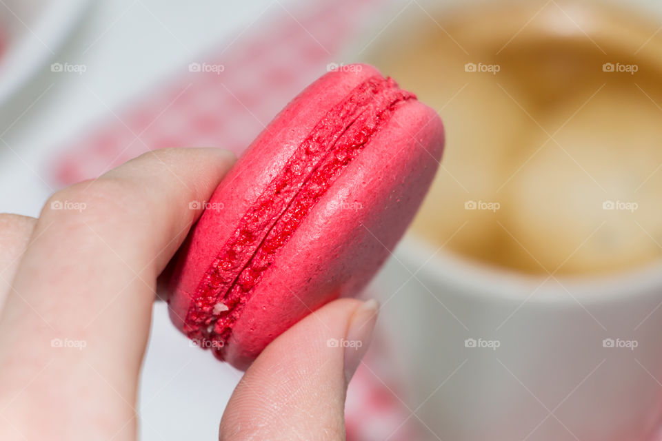 Women holding macaroon