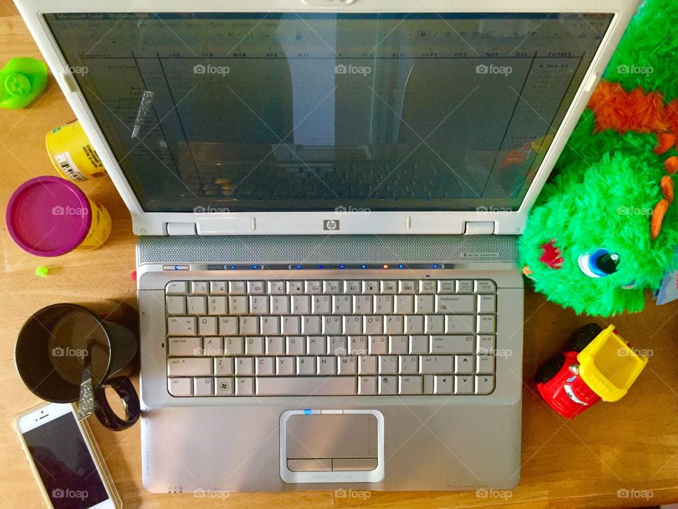 Mom, wanna play?. Mom's desk at home, covered in her son's toys.