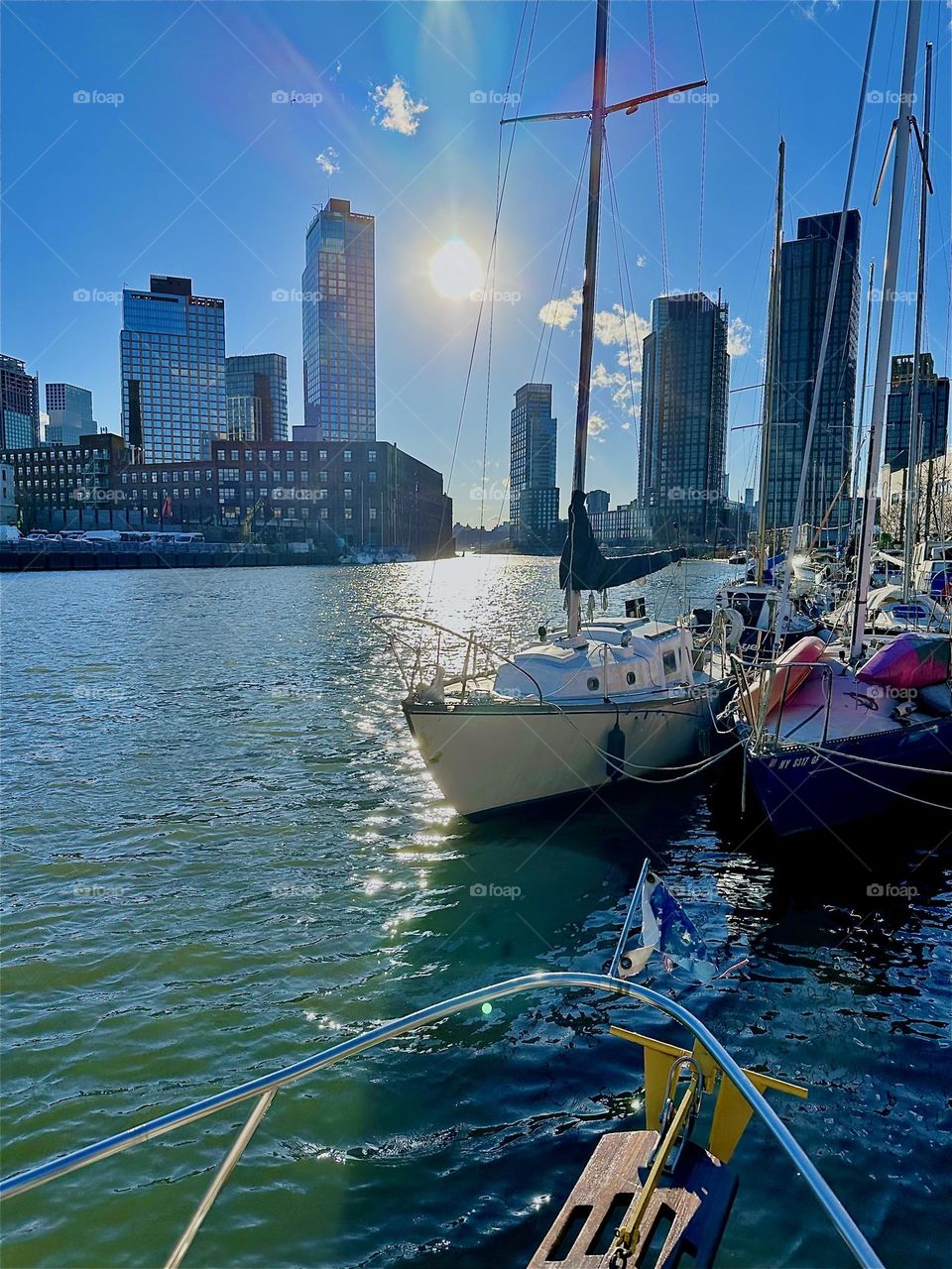 This is beautiful shimmering sparkling “Newtown Creek” by the “Pulaski Bridge” in LIC, Queens seen from the front deck of “Salvation”, a “28 ft 1969 Luhrs” cabin cruiser that is home to myself and partner “Timothy Trespas”. 2024. Hypnotic Productions