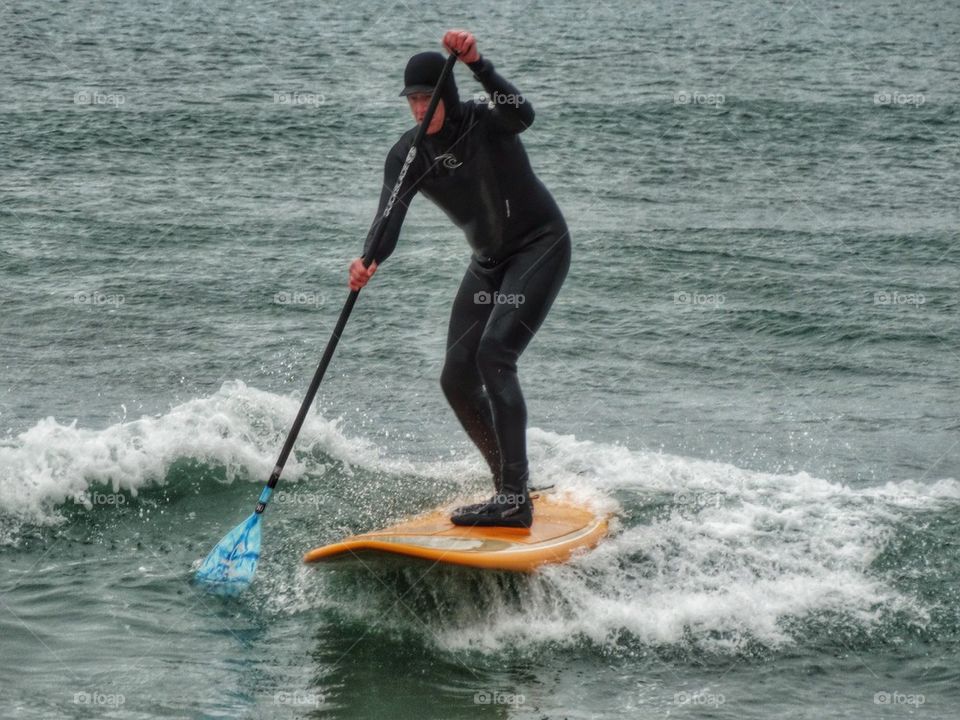 Man In Wetsuit On Paddleboard. Pacific Paddleboarding

