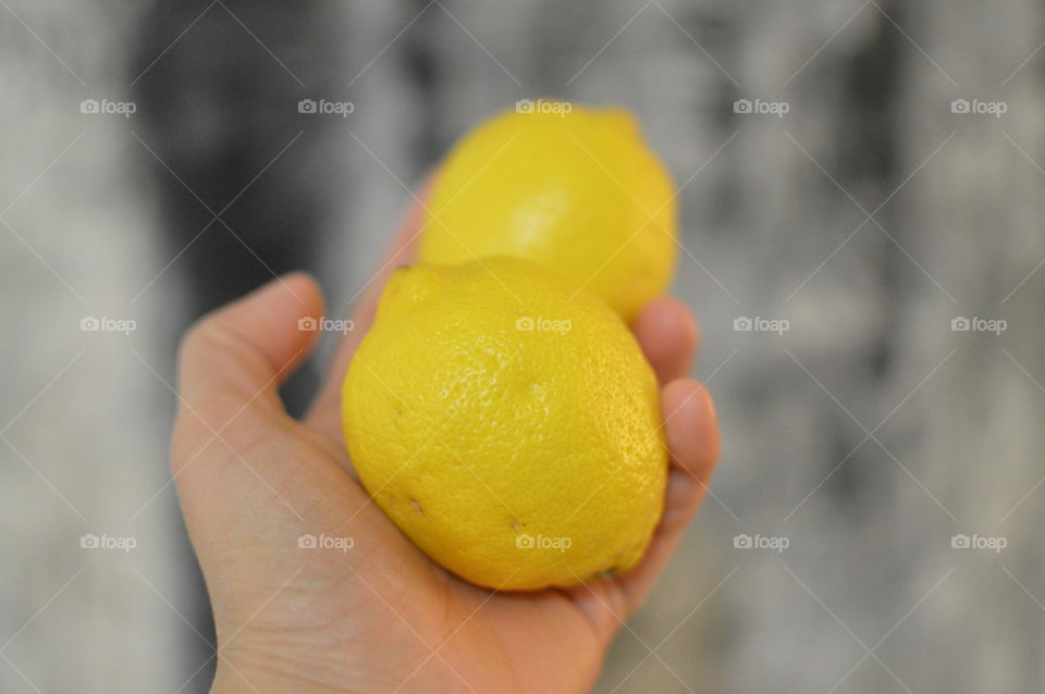 Close-up of lemon on hand