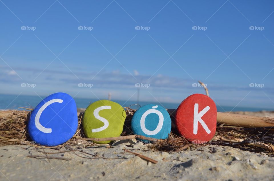 Csók, kiss in hungarian language on colourful stones