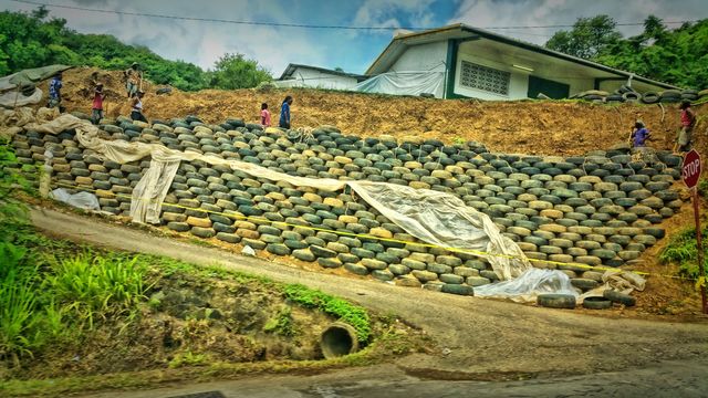 I found this to be so interestingly unique... these island men are building a tire wall...So glad I got to capture this...St Lucia
