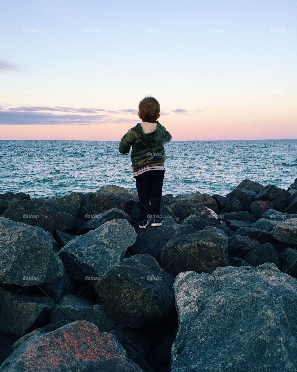 Child looking at sunset on Lake Superior
